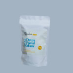 A bag of detox facial mask on a blue background.